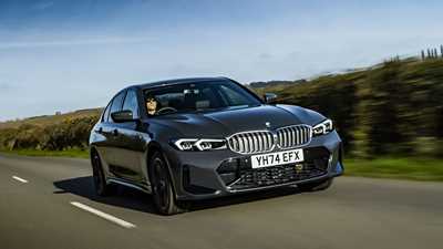 BMW 330e (2024) review: front three quarter driving, grey paint