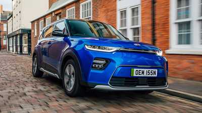Kia Soul EV review, blue, front view, driving on cobbled street